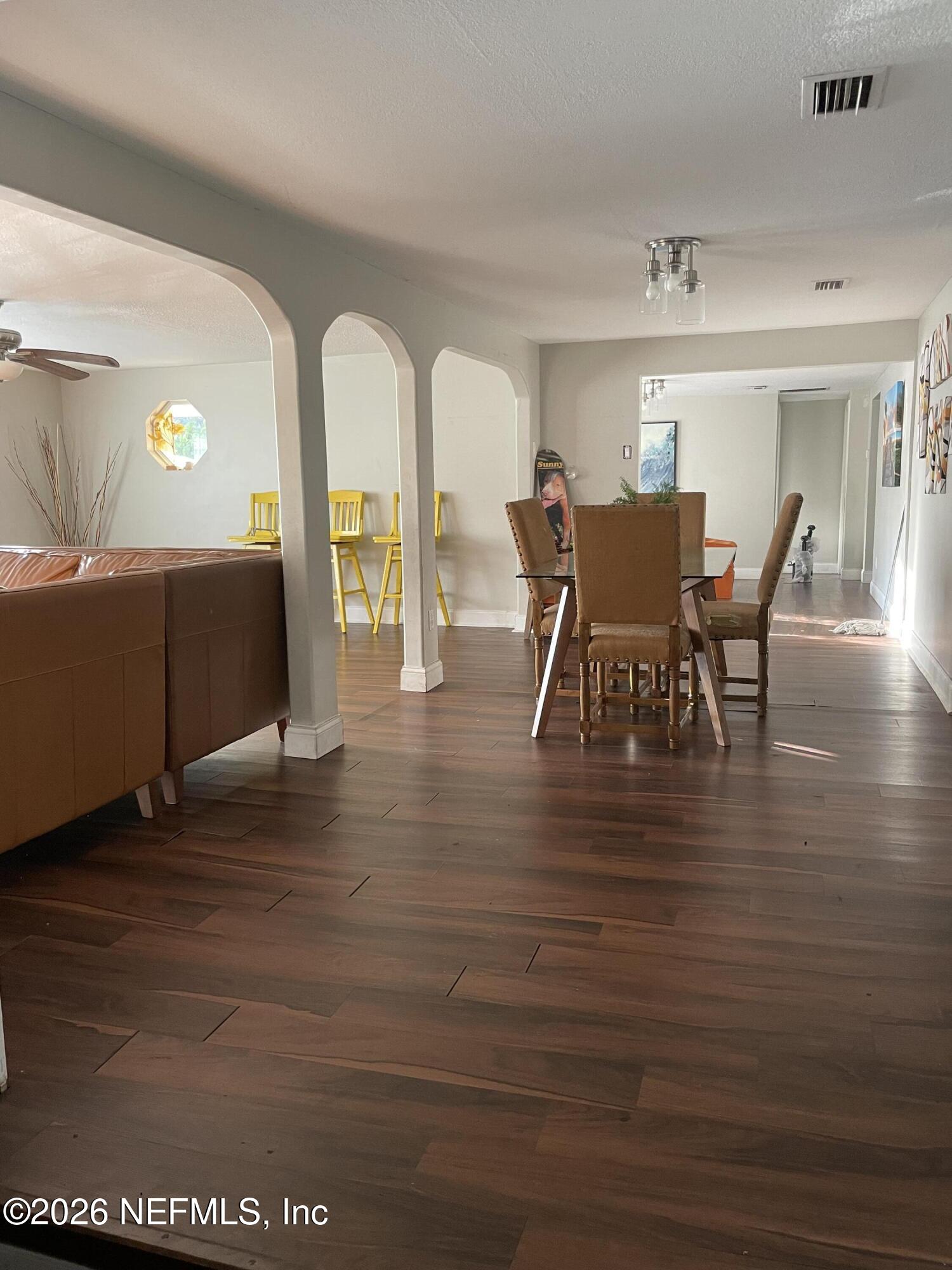 5884 Retha Road Jacksonville, FL 32254 - Photo 9 of 16 a view of a dining room with furniture and wooden floor
