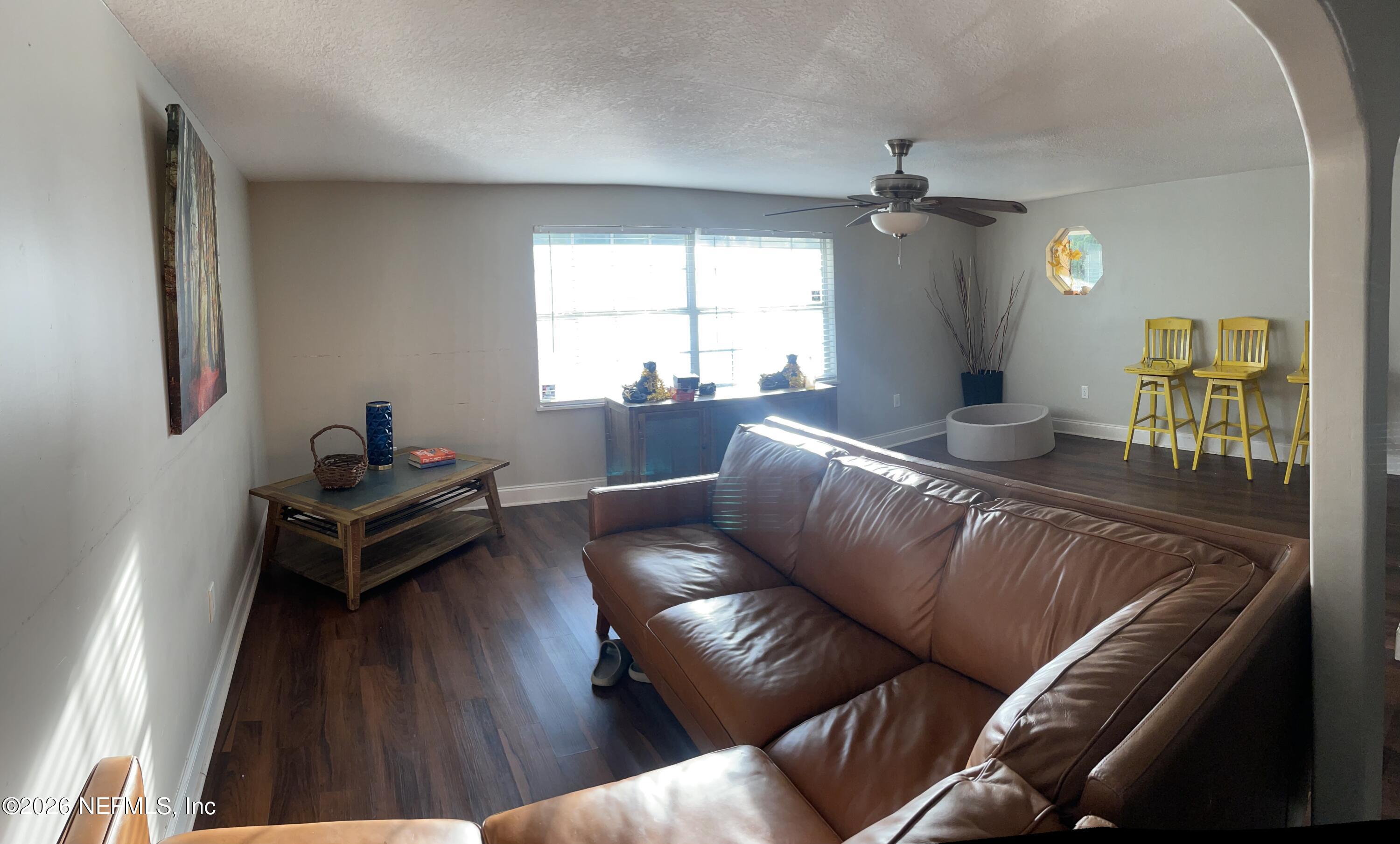 5884 Retha Road Jacksonville, FL 32254 - Photo 10 of 16 a living room with furniture and wooden floor