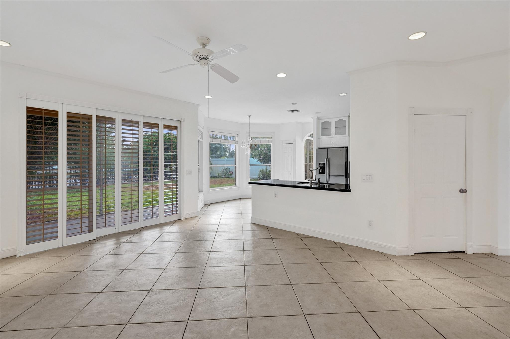 10902 Tamoron Lane Boca Raton, FL 33498 - Photo 12 of 66 a view of a kitchen with an empty space and a window