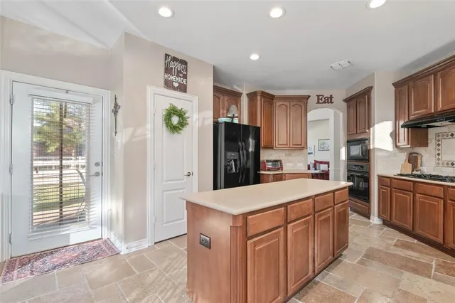 a kitchen with stainless steel appliances a refrigerator sink and cabinets