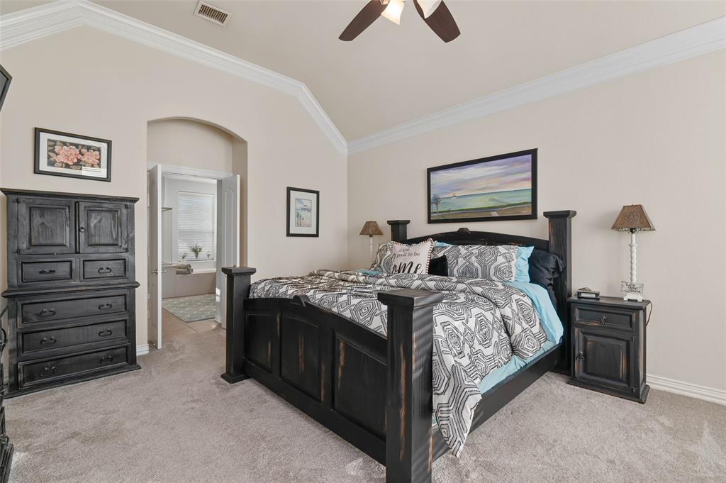 1100 Durango Circle Shady Shores, TX 76208 - Photo 16 of 39 a bedroom with a bed and a chandelier