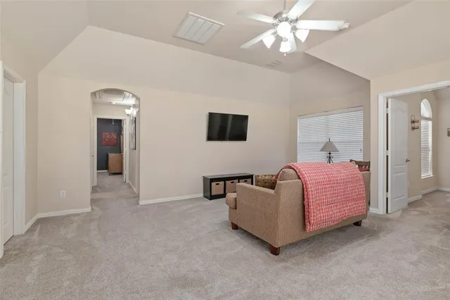 a living room with furniture and a ceiling fan