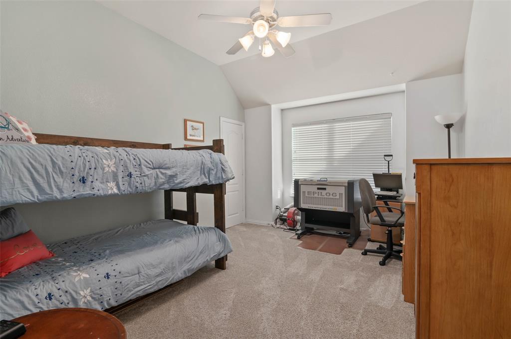 1100 Durango Circle Shady Shores, TX 76208 - Photo 25 of 39 a bedroom with a bed and a chandelier