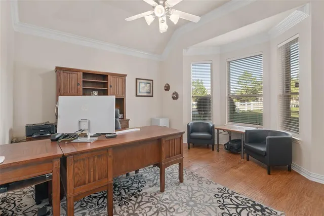 a view of a workspace with furniture and a window