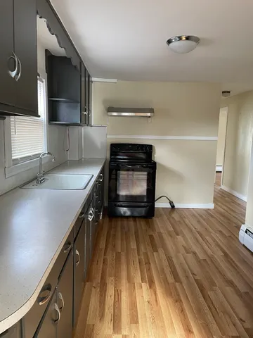 a kitchen with a sink and a stove top oven