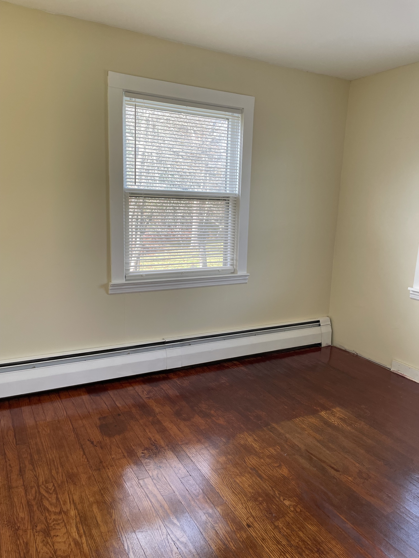 683 Camp Street Bristol, CT 06010 - Photo 7 of 9 an empty room with wooden floor and windows