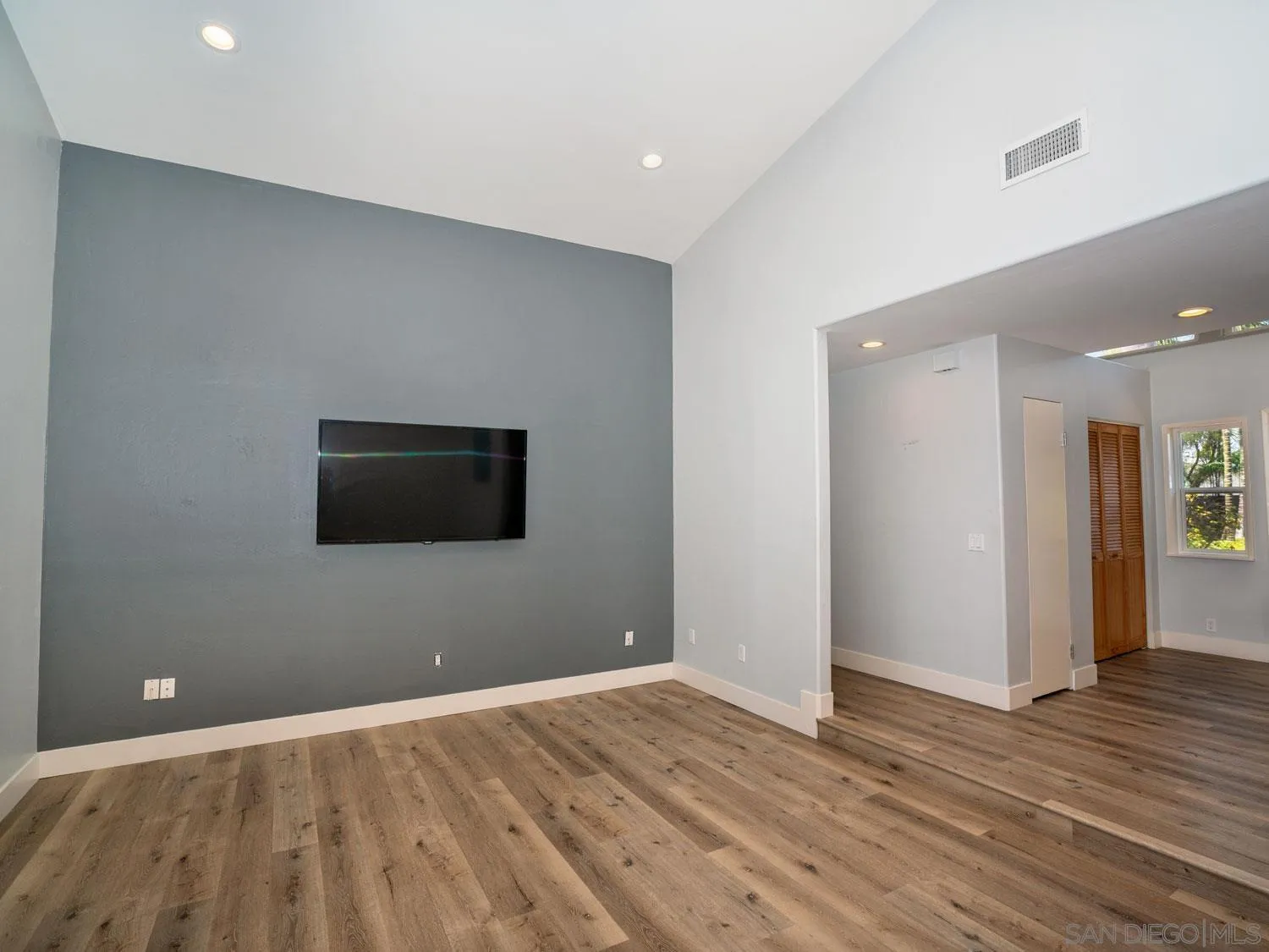 2043 Janet Circle Oceanside, CA 92054 - Photo 12 of 27 a view of an empty room with wooden floor and a window
