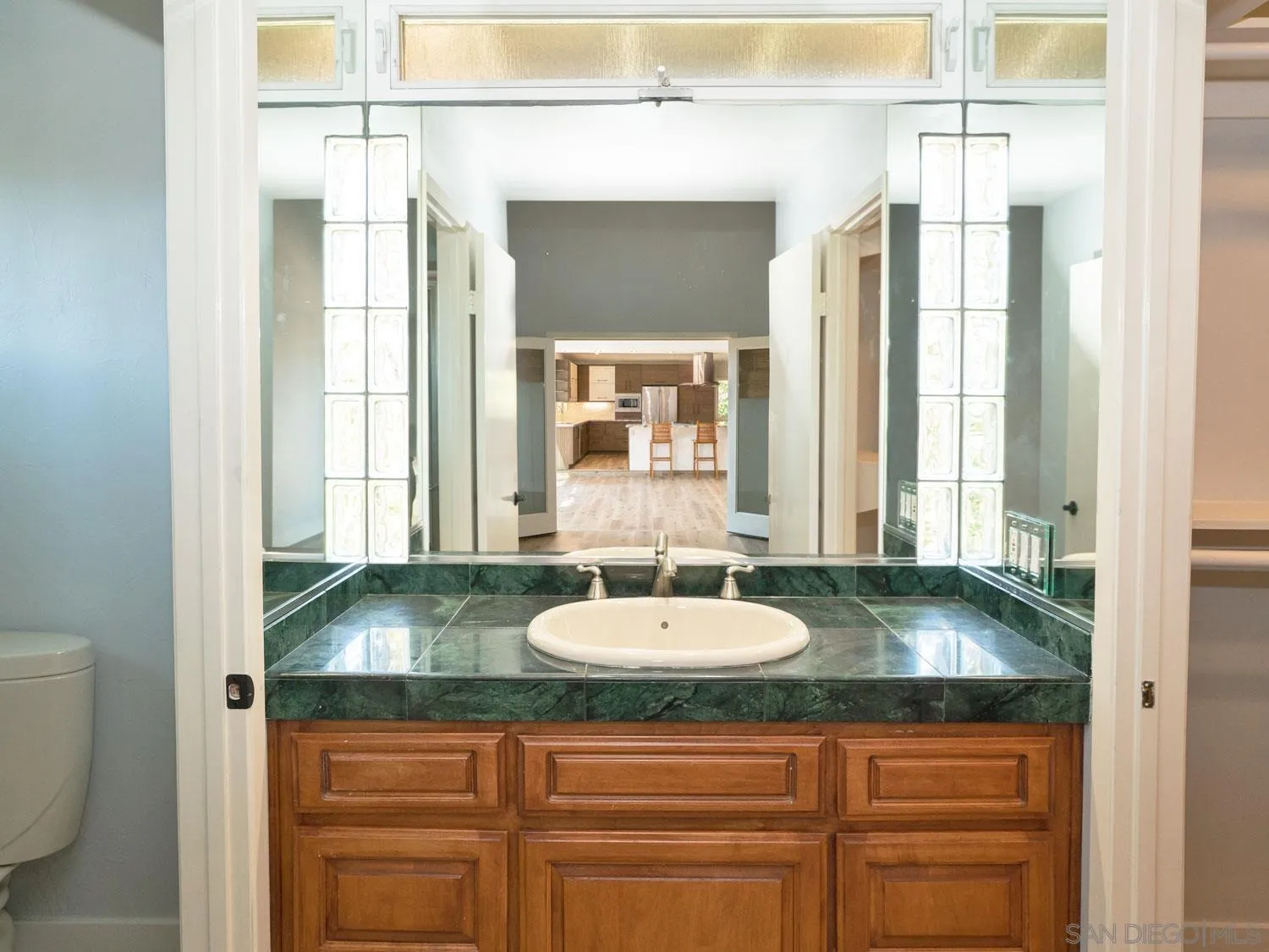 2043 Janet Circle Oceanside, CA 92054 - Photo 14 of 27 a bathroom with a granite countertop sink and a mirror