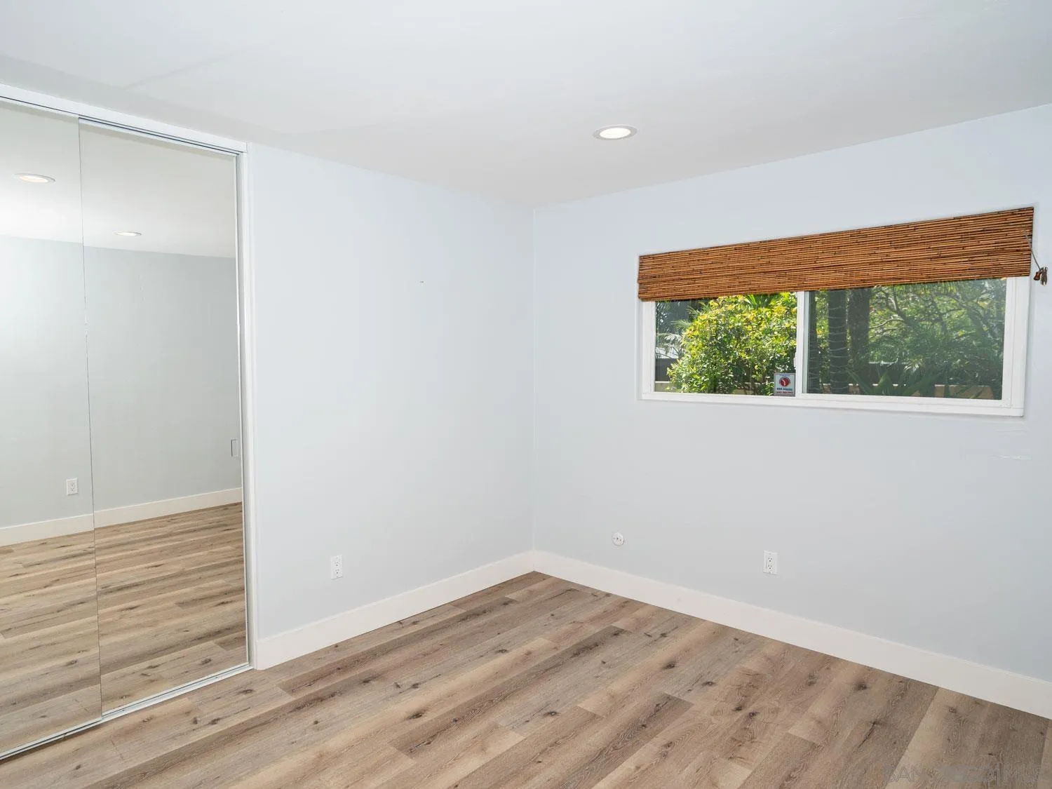 2043 Janet Circle Oceanside, CA 92054 - Photo 15 of 27 an empty room with wooden floor and windows