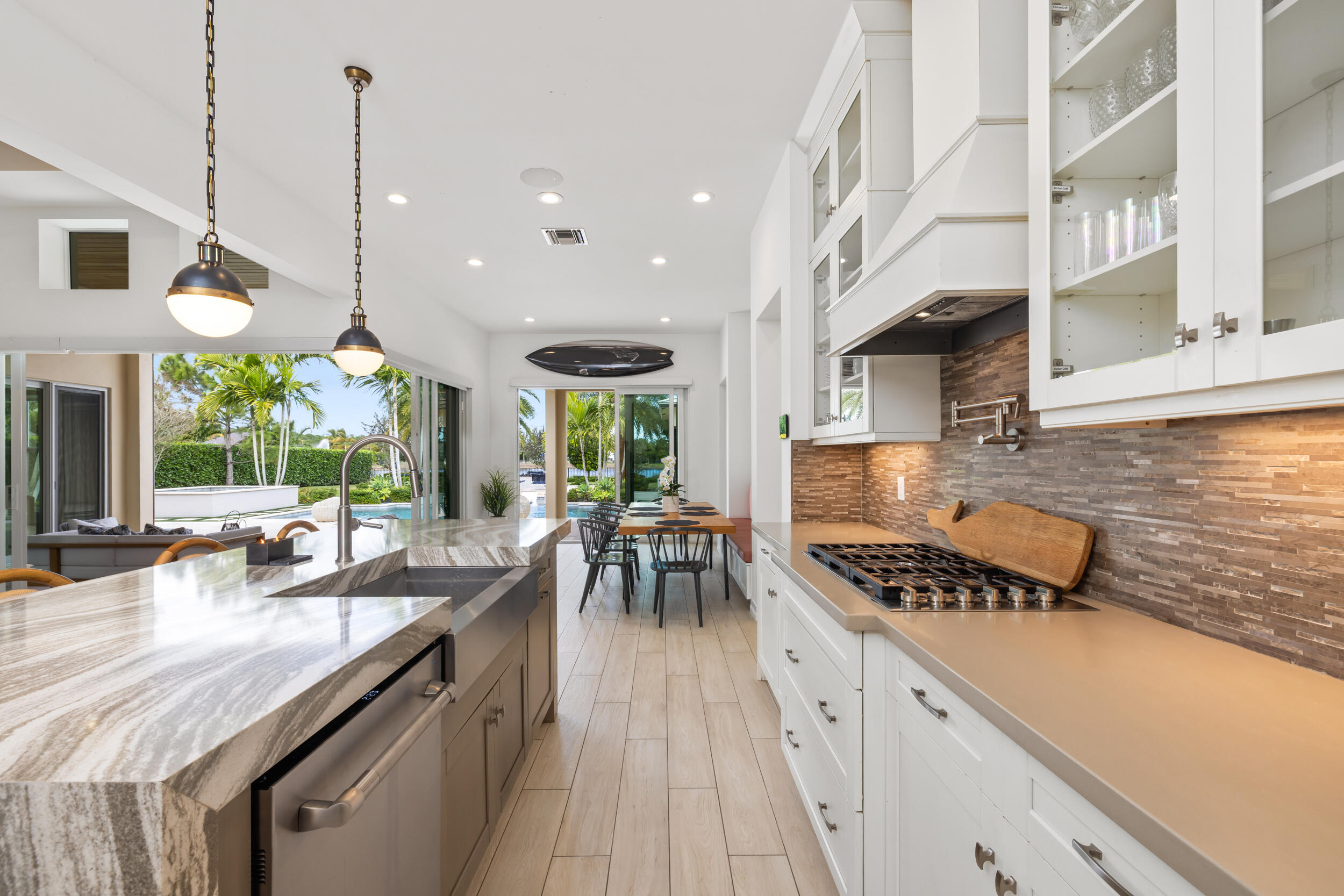 8001 Southeast Plantation Circle Jupiter, FL 33458 - Photo 14 of 50 a kitchen with stainless steel appliances granite countertop a stove a sink and a wooden floors