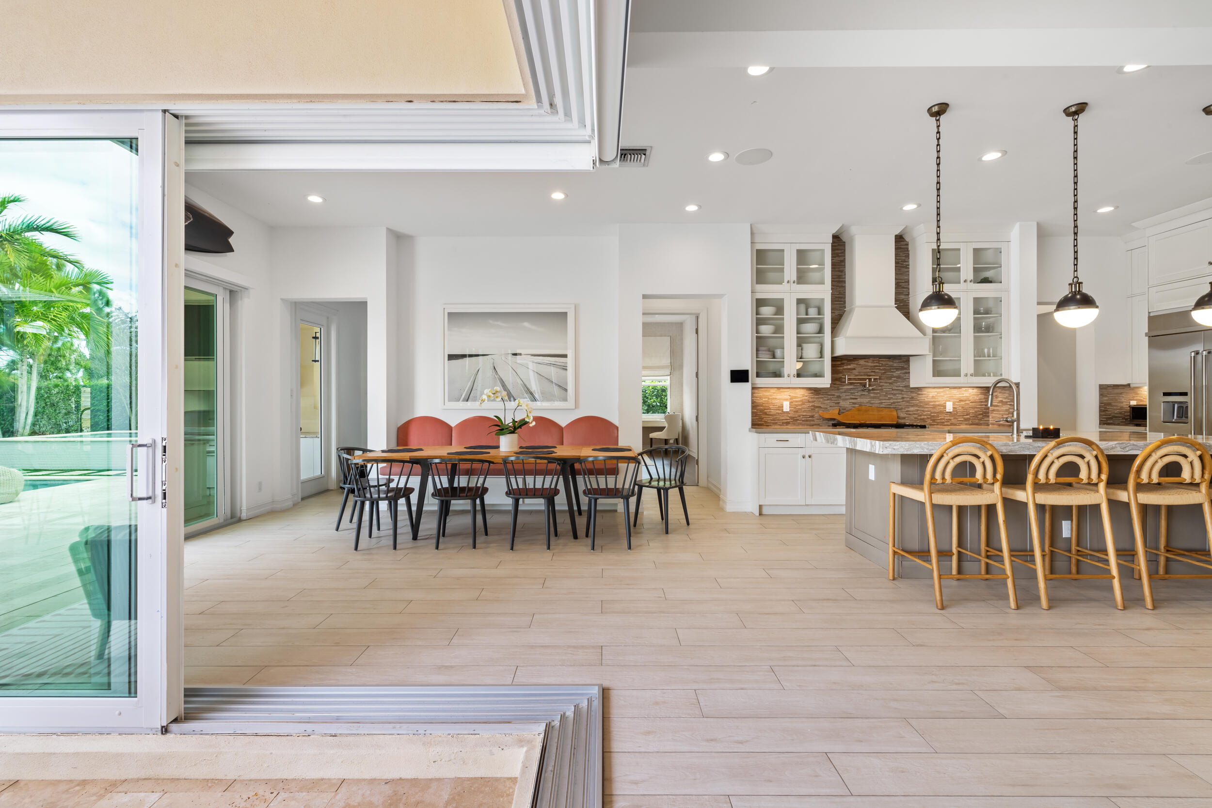 8001 Southeast Plantation Circle Jupiter, FL 33458 - Photo 16 of 50 a dining hall view with a large dining table and a large window with garden view