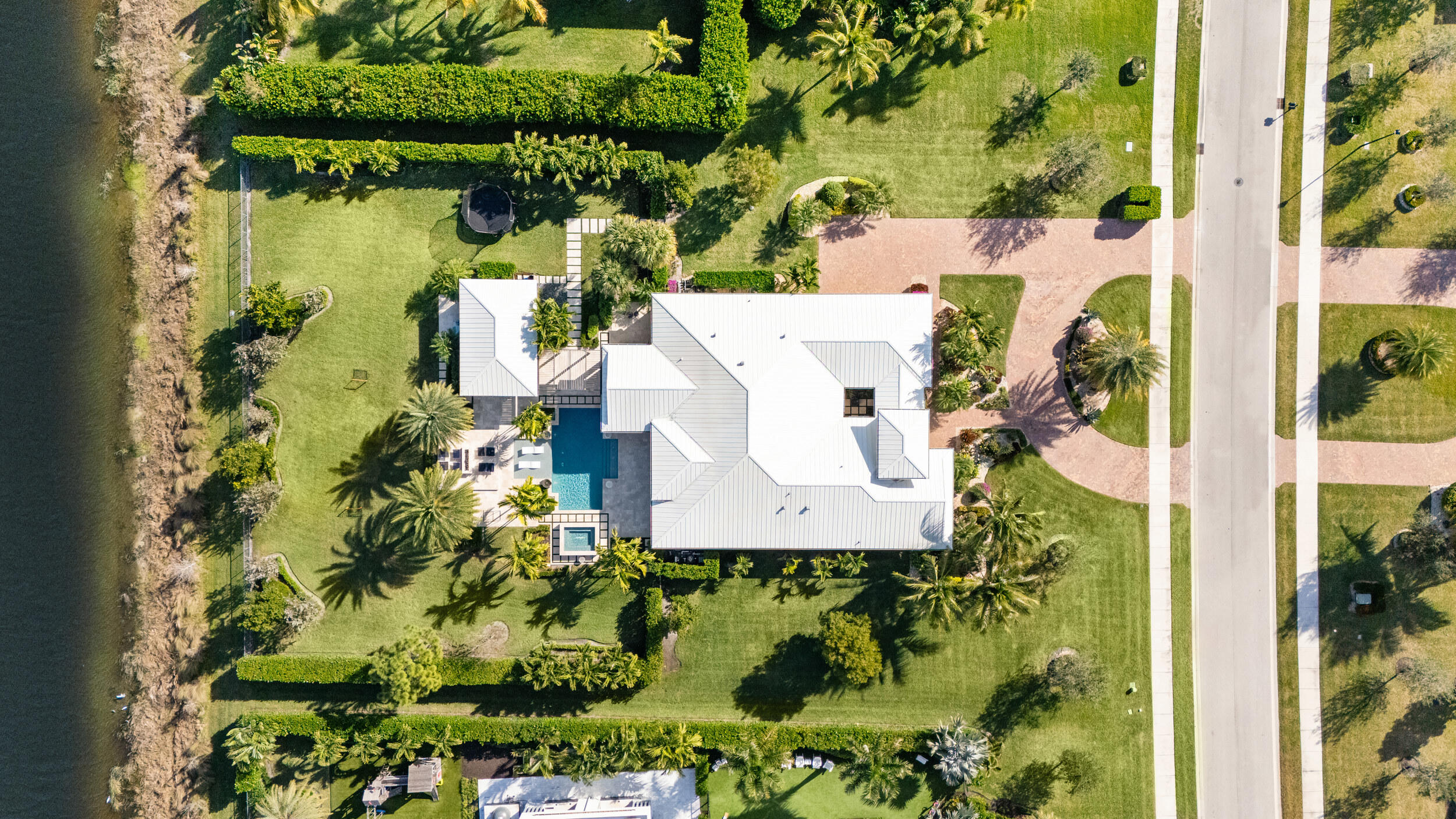8001 Southeast Plantation Circle Jupiter, FL 33458 - Photo 2 of 50 an aerial view of a house with a yard