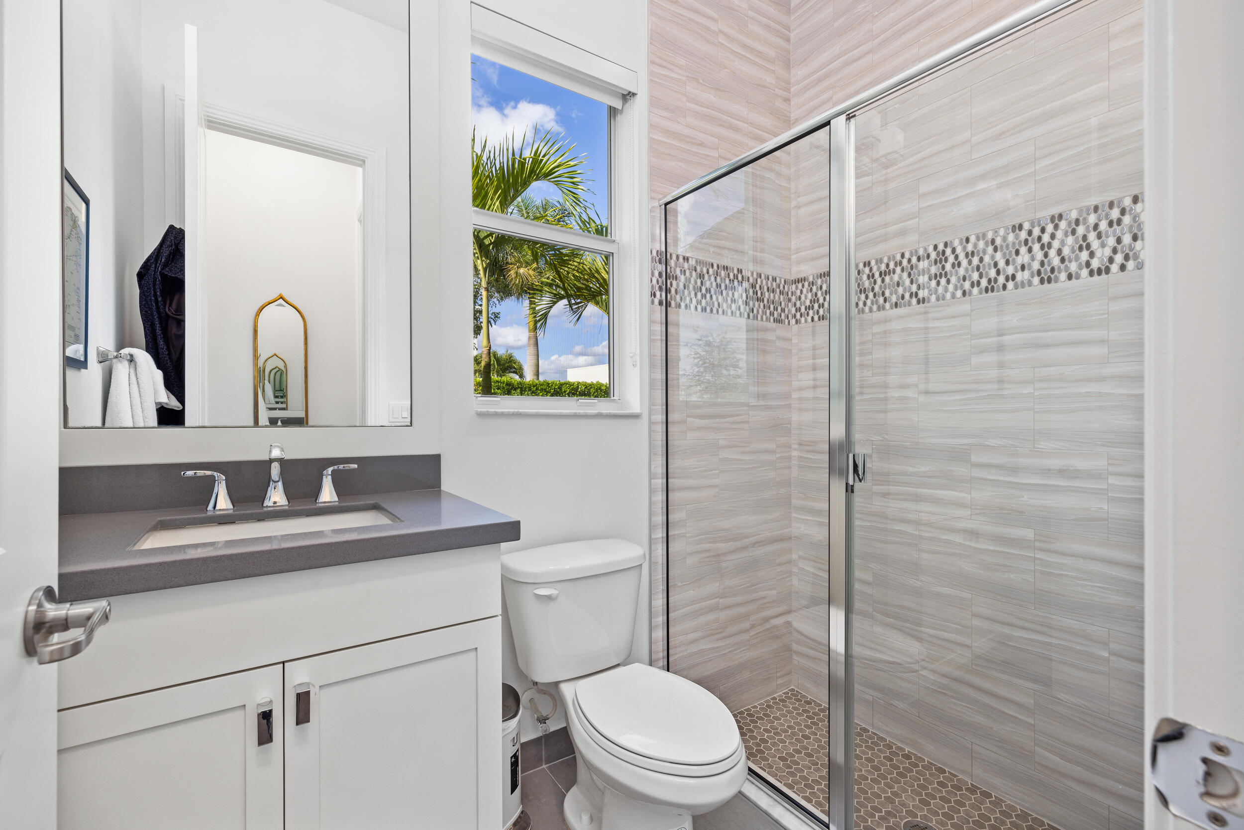 8001 Southeast Plantation Circle Jupiter, FL 33458 - Photo 22 of 50 a bathroom with a toilet sink vanity and mirror