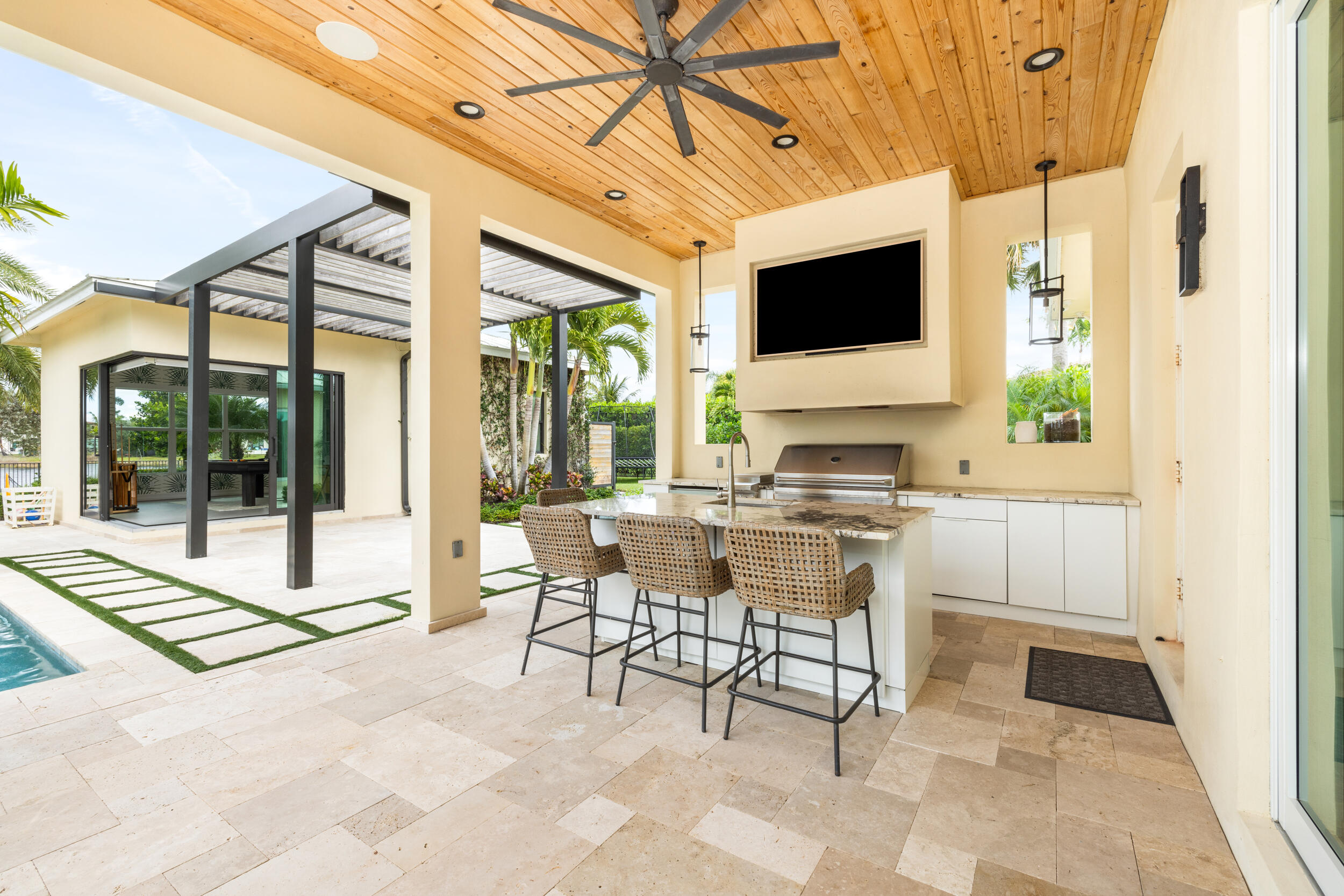 8001 Southeast Plantation Circle Jupiter, FL 33458 - Photo 34 of 50 a living room with a flat screen tv and a floor to ceiling window