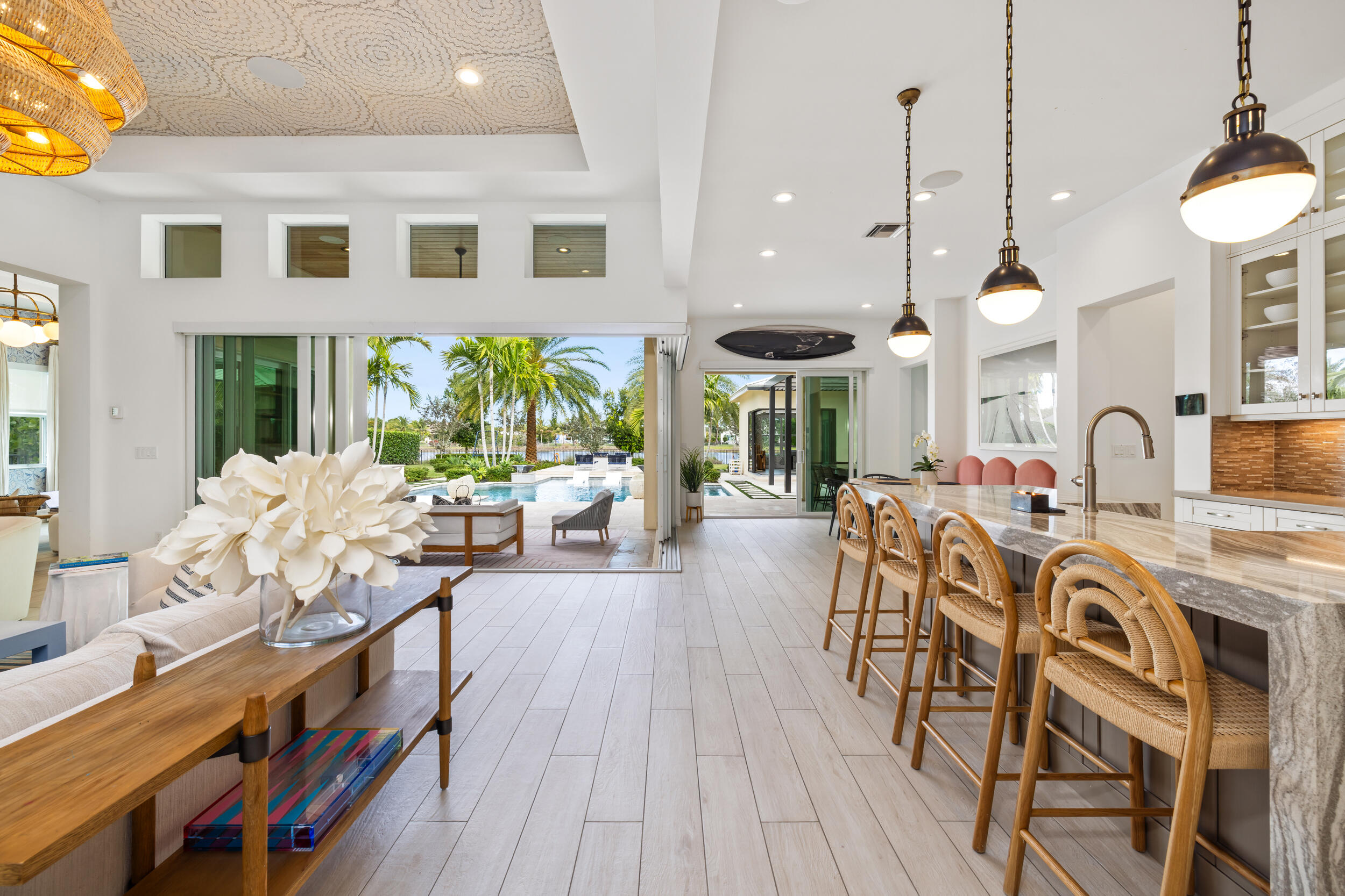 8001 Southeast Plantation Circle Jupiter, FL 33458 - Photo 8 of 50 a living room with furniture a chandelier and a wooden floor