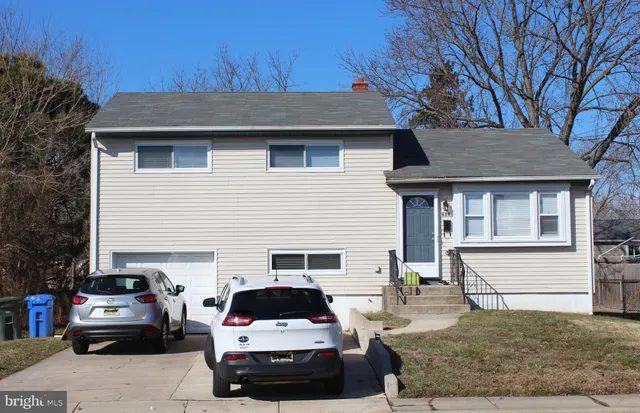 a car parked in front of white house