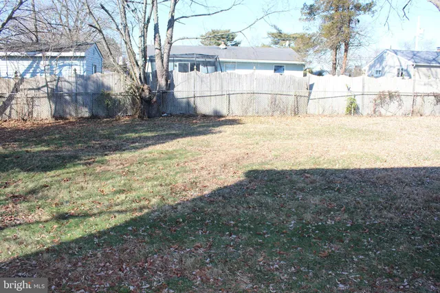 a view of yard with wooden fence