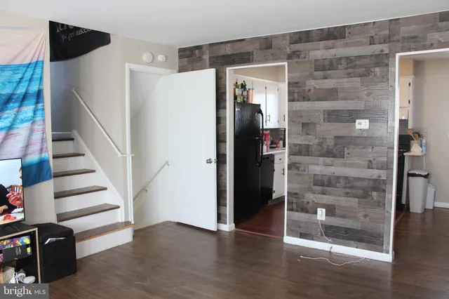 a view of a hallway with wooden floor and entryway