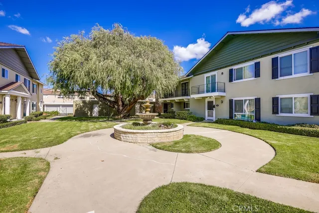 a front view of a house with a yard table and chairs