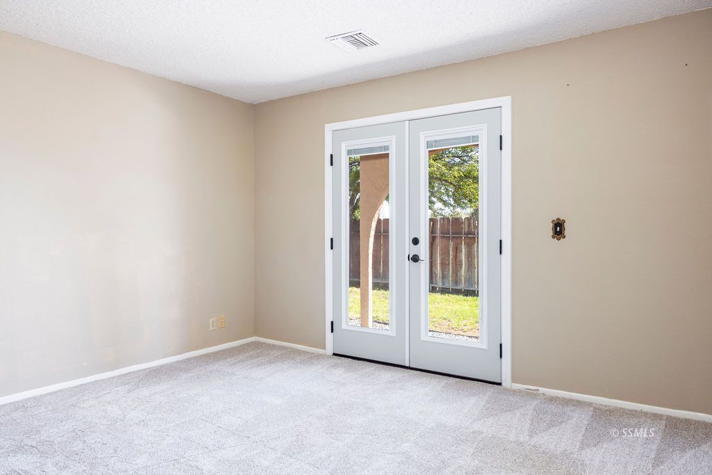 1144 West Benson Avenue Ridgecrest, CA 93555 - Photo 21 of 32 a view of an empty room with a window
