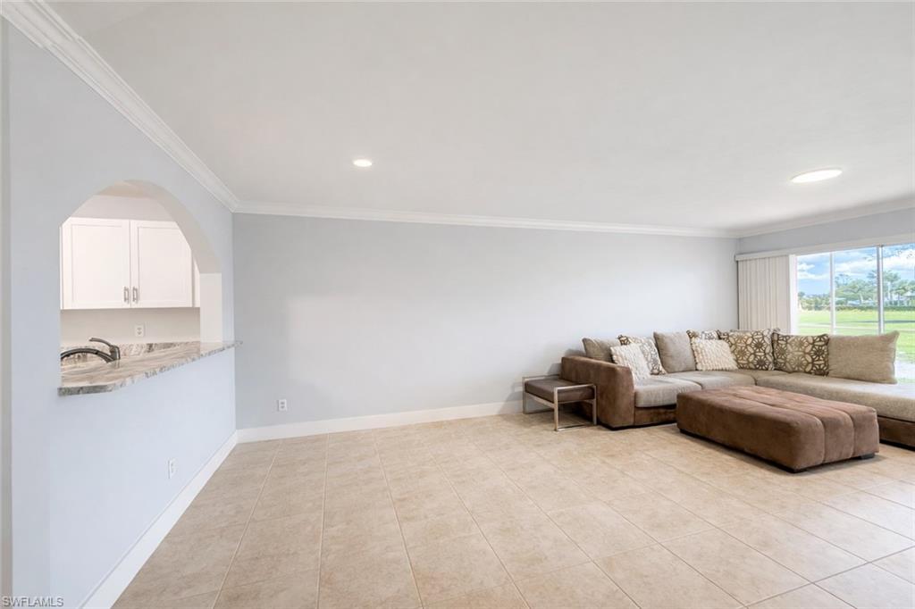 534 Augusta Boulevard, Unit E104 Naples, FL 34113 - Photo 15 of 26 a living room with furniture and a window