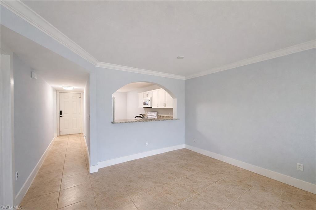 534 Augusta Boulevard, Unit E104 Naples, FL 34113 - Photo 16 of 26 an empty room with mirror and windows