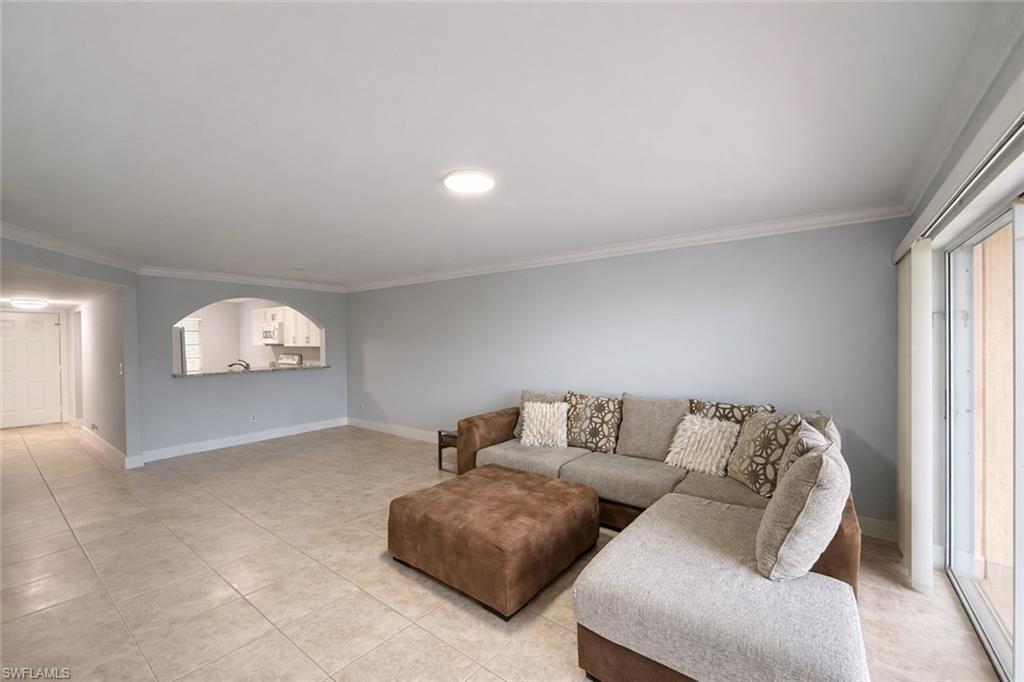 534 Augusta Boulevard, Unit E104 Naples, FL 34113 - Photo 17 of 26 a living room with furniture and a window