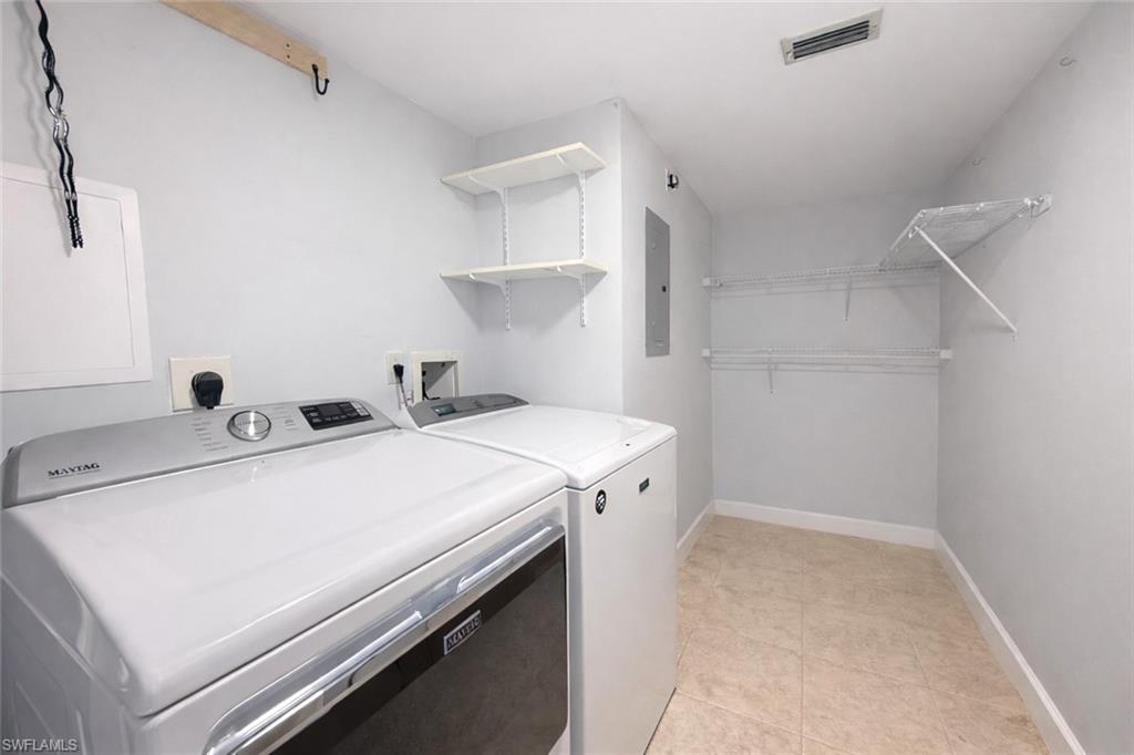 534 Augusta Boulevard, Unit E104 Naples, FL 34113 - Photo 22 of 26 a utility room with dryer and washer