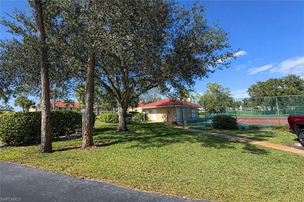 534 Augusta Boulevard, Unit E104 Naples, FL 34113 - Photo 26 of 26 a front view of a house with a yard