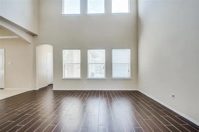 a view of room with window and wooden floor