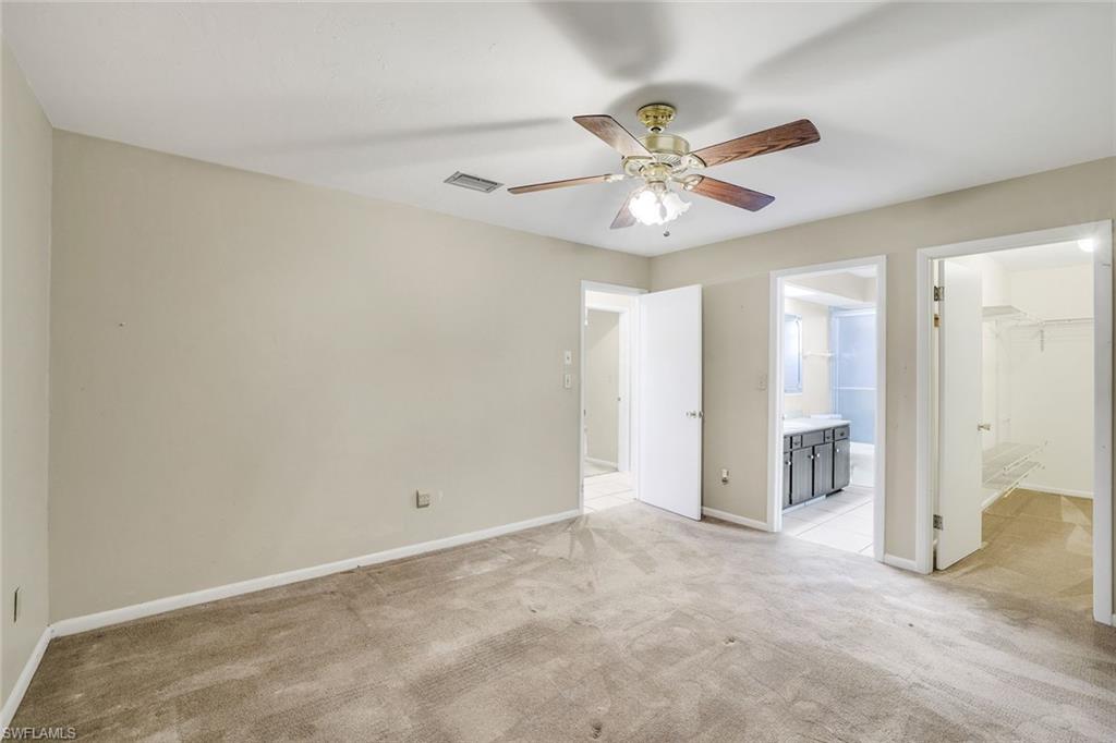 5290 Cypress Lane Naples, FL 34113 - Photo 17 of 39 a view of an empty room and chandelier fan
