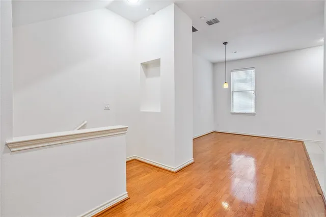 a view of room with window and hardwood floor