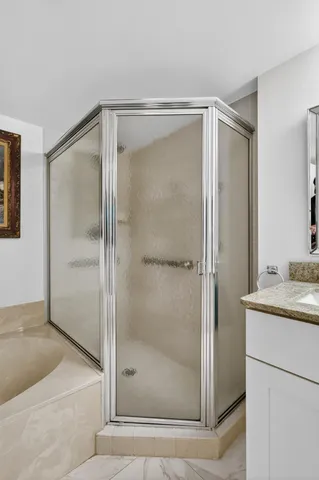 a bathroom with a shower and a sink