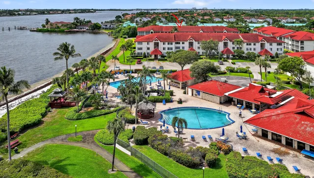 an aerial view of a house with outdoor space and lake view