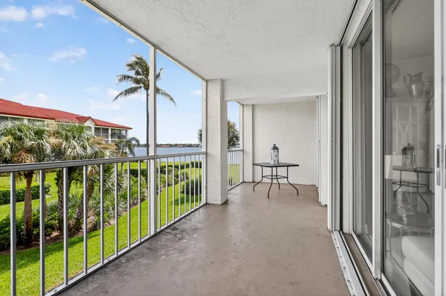 a view of a porch with furniture and a yard