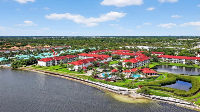 an aerial view of lake residential house with swimming pool and outdoor seating