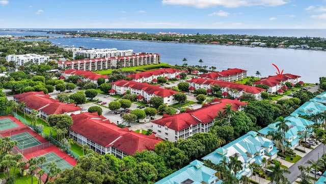 a car parked in front of a house with a yard