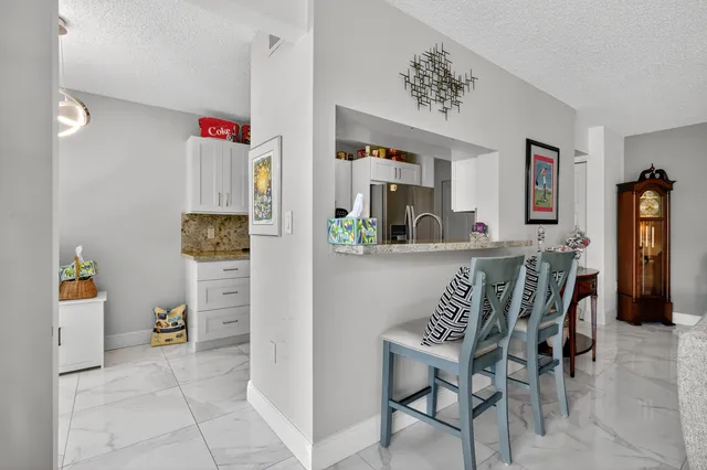 a view of dining room and kitchen with furniture and wooden floor