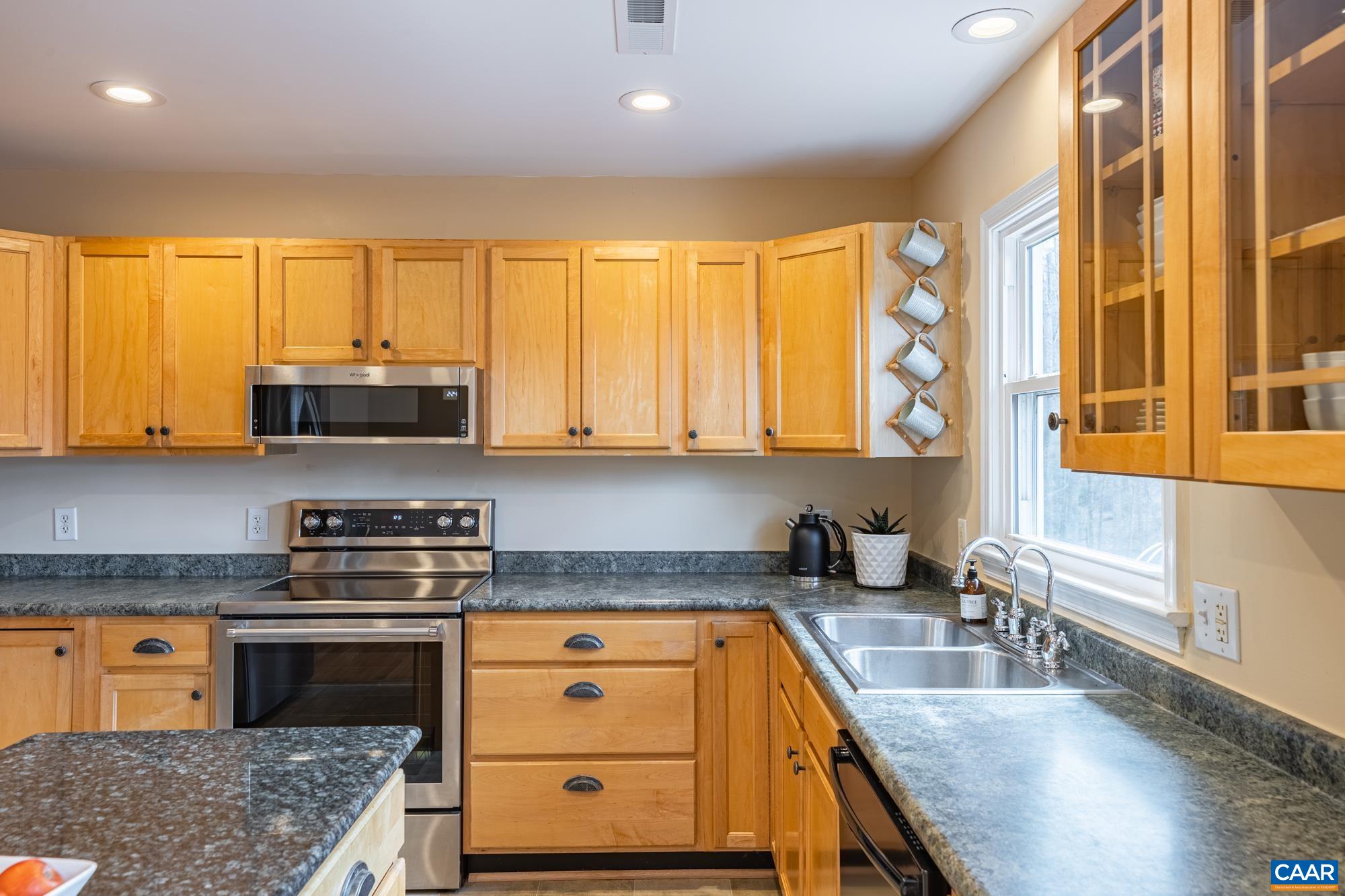 788 Dry Bridge Road Charlottesville, VA 22903 - Photo 17 of 54 a kitchen with stainless steel appliances granite countertop a stove a sink and a microwave