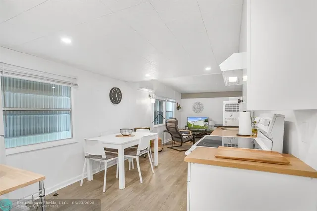 a view of a dining room with furniture and a window