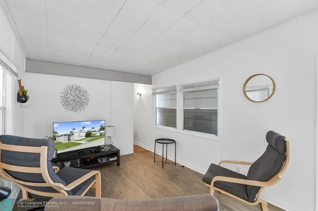 a living room with furniture a rug and a flat screen tv