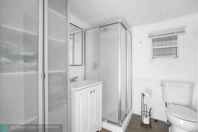 a bathroom with a shower a toilet and a sink