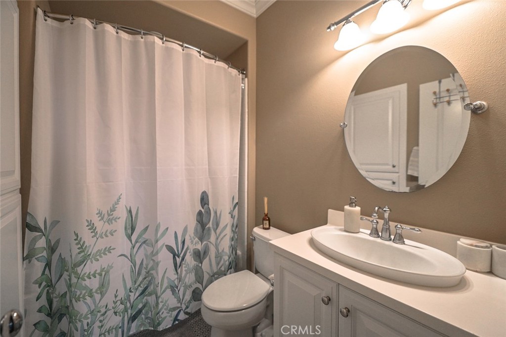 64 Scarlet Bloom Irvine, CA 92618 - Photo 19 of 22 a bathroom with a sink toilet and mirror