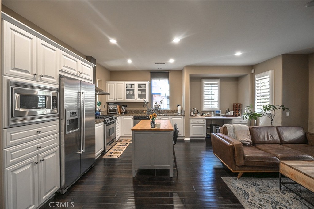 64 Scarlet Bloom Irvine, CA 92618 - Photo 6 of 22 a living room with stainless steel appliances furniture refrigerator and kitchen view