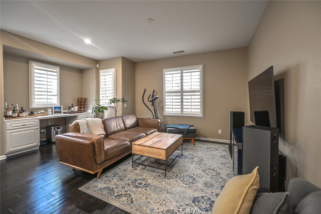64 Scarlet Bloom Irvine, CA 92618 - Photo 10 of 22 a living room with furniture and a flat screen tv
