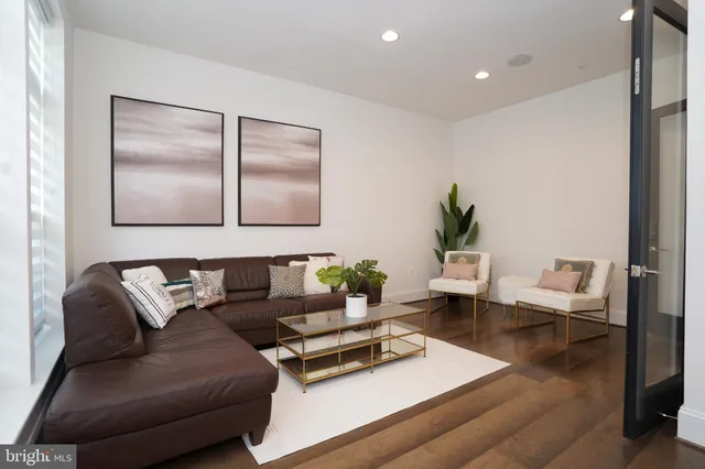 a view of a hallway with wooden floor and stairs