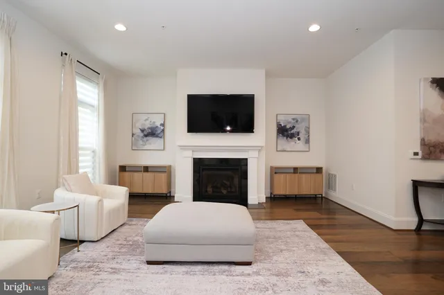a kitchen with a refrigerator and white cabinets