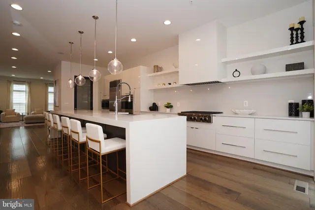 a white bath tub sitting next to a white wall