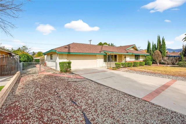a view of an house with backyard space and balcony