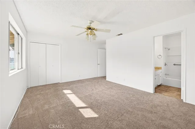 a bathroom with a granite countertop sink a mirror and a bathtub